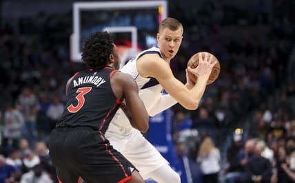 Jan 19, 2022; Dallas, Texas, USA;  Dallas Mavericks center Kristaps Porzingis (6) controls the ball as Toronto Raptors forward OG Anunoby (3) defends during the first quarter at American Airlines Center. Mandatory Credit: Kevin Jairaj-USA TODAY Sports