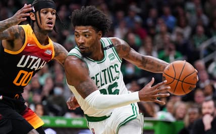 Mar 23, 2022; Boston, Massachusetts, USA; Boston Celtics guard Marcus Smart (36) drives the ball against Utah Jazz guard Jordan Clarkson (00) in the first quarter at TD Garden. Mandatory Credit: David Butler II-USA TODAY Sports