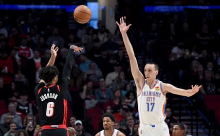 Mar 28, 2022; Portland, Oregon, USA; Portland Trail Blazers guard Keon Johnson (6) shoots over Oklahoma City Thunder center Aleksej Pokusevski (17) during the first quarter of the game at Moda Center. Mandatory Credit: Steve Dykes-USA TODAY Sports