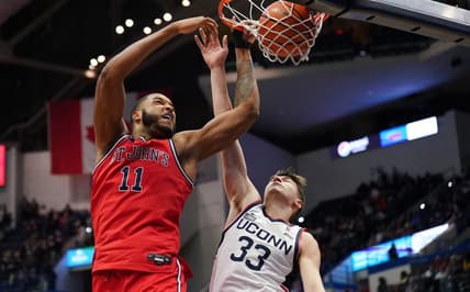 Jan 15, 2023; Hartford, Connecticut, USA; St. John's Red Storm center Joel Soriano (11) shoots against UConn Huskies guard Apostolos Roumoglou (33) in the second half at XL Center. Mandatory Credit: David Butler II-USA TODAY Sports