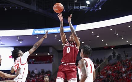 Jan 22, 2023; Houston, Texas, USA; Temple Owls guard Khalif Battle (0) shoots the ball as Houston Cougars guard Terrance Arceneaux (23) defends during the first half at Fertitta Center. Mandatory Credit: Troy Taormina-USA TODAY Sports
