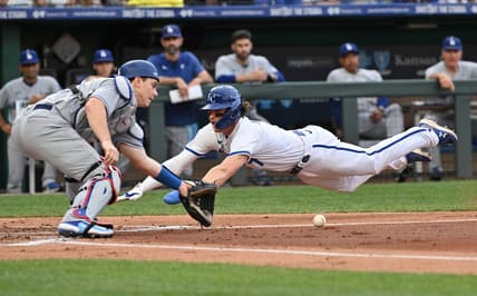 Jul 1, 2023; Kansas City, Missouri, USA;  Kansas City Royals shortstop Bobby Witt Jr. (7) dives home to score a run against Los Angeles Dodgers catcher Will Smith (16) in the first inning at Kauffman Stadium. Mandatory Credit: Peter Aiken-USA TODAY Sports