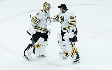 Oct 24, 2023; Chicago, Illinois, USA; Boston Bruins goaltender Jeremy Swayman (1) and goaltender Linus Ullmark (35) celebrate their win against the Chicago Blackhawks at United Center. Mandatory Credit: David Banks-USA TODAY Sports