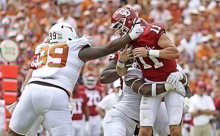 Oct 8, 2022; Dallas, Texas, USA;  Texas Longhorns defensive end Justice Finkley (1) and Texas Longhorns defensive lineman Keondre Coburn (99) sack Oklahoma Sooners quarterback Davis Beville (11) during the second half at the Cotton Bowl. Mandatory Credit: Kevin Jairaj-USA TODAY Sports