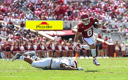 Sep 2, 2023; Norman, Oklahoma, USA; Oklahoma Sooners quarterback Dillon Gabriel (8) runs past Arkansas State Red Wolves defensive lineman Micah Bland (55) during the second quarter at Gaylord Family-Oklahoma Memorial Stadium. Mandatory Credit: Kevin Jairaj-USA TODAY Sports