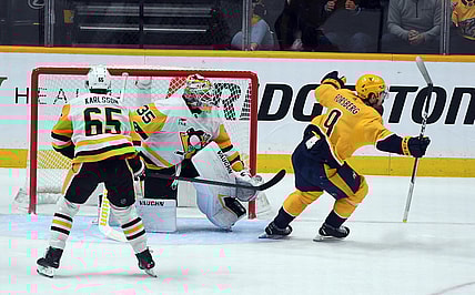 Nov 28, 2023; Nashville, Tennessee, USA; Nashville Predators left wing Filip Forsberg (9) scores the game-winning goal against Pittsburgh Penguins goaltender Tristan Jarry (35) in overtime at Bridgestone Arena. Mandatory Credit: Christopher Hanewinckel-USA TODAY Sports
