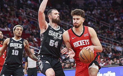 Dec 11, 2023; Houston, Texas, USA; Houston Rockets center Alperen Sengun (28) controls the ball as San Antonio Spurs forward Sandro Mamukelashvili (54) defends during the second quarter at Toyota Center. Mandatory Credit: Troy Taormina-USA TODAY Sports