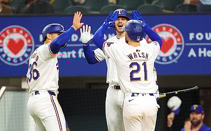 Mar 30, 2024; Arlington, Texas, USA;  Texas Rangers first baseman Jared Walsh (21) celebrates with Texas Rangers designated hitter Wyatt Langford (36) and Texas Rangers catcher Jonah Heim (28) after hitting a two-run home run during the second inning against the Chicago Cubs at Globe Life Field. Mandatory Credit: Kevin Jairaj-USA TODAY Sports