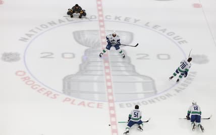 Aug 23, 2020; Edmonton, Alberta, CAN; Vancouver Canucks and Vegas Golden Knights players warm up at the center logo before game one of the second round of the 2020 Stanley Cup Playoffs at Rogers Place. Mandatory Credit: Gerry Thomas-USA TODAY Sports