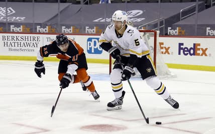 Apr 15, 2021; Pittsburgh, Pennsylvania, USA;  Pittsburgh Penguins defenseman Mike Matheson (5) moves the puck out of the defensive zone as Philadelphia Flyers right wing Travis Konecny (11) chases during the second period  at PPG Paints Arena. Mandatory Credit: Charles LeClaire-USA TODAY Sports
