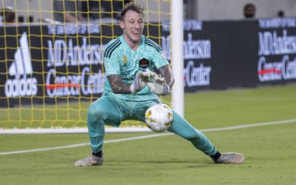 Sep 10, 2022; Houston, Texas, USA; Houston Dynamo FC goalkeeper Steve Clark (12) defects a shot during stoppage time in the second half against the Sporting Kansas City at PNC Stadium. Mandatory Credit: Troy Taormina-USA TODAY Sports