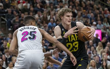 Dec 31, 2022; Salt Lake City, Utah, USA; Utah Jazz forward-center Lauri Markkanen (23) battles for a rebound against Miami Heat center Orlando Robinson (25) during the first quarter at Vivint Arena. Mandatory Credit: Christopher Creveling-USA TODAY Sports