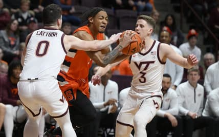 Jan 28, 2023; Blacksburg, Virginia, USA; Syracuse Orange guard Judah Mintz (3) is defended by Virginia Tech Hokies guard Hunter Cattoor (0) and guard Sean Pedulla (3) in the first half at Cassell Coliseum. Mandatory Credit: Lee Luther Jr.-USA TODAY Sports