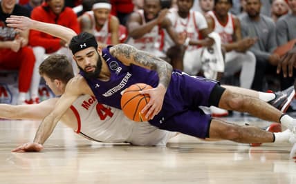 Feb 9, 2023; Columbus, Ohio, USA; Northwestern Wildcats guard Boo Buie (0) dives for the loose ball with Ohio State Buckeyes guard Sean McNeil (4) during the first half at Value City Arena. Mandatory Credit: Joseph Maiorana-USA TODAY Sports