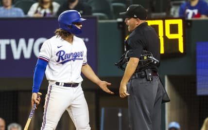 Apr 12, 2023; Arlington, Texas, USA;  Texas Rangers shortstop Josh Smith (47) argues with umpire Jansen Visconti (52) after striking out during the ninth inning at Globe Life Field. Mandatory Credit: Kevin Jairaj-USA TODAY Sports
