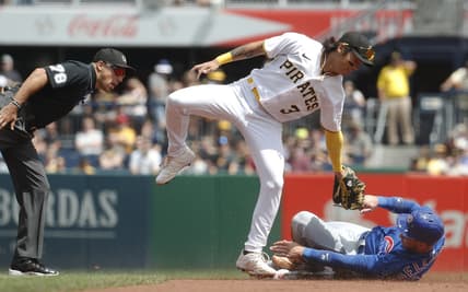 Aug 27, 2023; Pittsburgh, Pennsylvania, USA;  Chicago Cubs designated hitter Cody Bellinger (right) steals second base as Pittsburgh Pirates second baseman Ji Hwan Bae (3) applies a late tag during the first inning at PNC Park. Mandatory Credit: Charles LeClaire-USA TODAY Sports