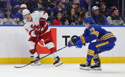 Feb 25, 2024; Buffalo, New York, USA;  Buffalo Sabres defenseman Jacob Bryson (78) tries to block a pass by Carolina Hurricanes right wing Jesper Fast (71) during the first period at KeyBank Center. Mandatory Credit: Timothy T. Ludwig-USA TODAY Sports
