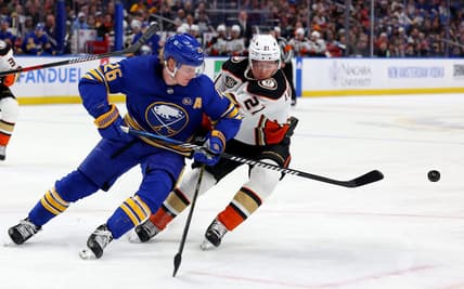 Feb 19, 2024; Buffalo, New York, USA;  Buffalo Sabres defenseman Rasmus Dahlin (26) clears the puck as Anaheim Ducks center Isac Lundestrom (21) defends during the first period at KeyBank Center. Mandatory Credit: Timothy T. Ludwig-USA TODAY Sports