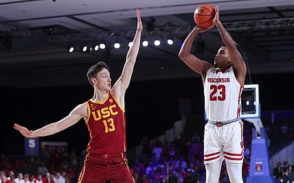 Nov 25, 2022; Paradise Island, BAHAMAS; Wisconsin Badgers guard Chucky Hepburn (23) shoots over USC Trojans guard Drew Peterson (13) during the first half at Imperial Arena. Mandatory Credit: Kevin Jairaj-USA TODAY Sports