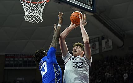 Jan 7, 2023; Storrs, Connecticut, USA; UConn Huskies center Donovan Clingan (32) shoots against Creighton Bluejays center Fredrick King (33) in the first half at Harry A. Gampel Pavilion. Mandatory Credit: David Butler II-USA TODAY Sports