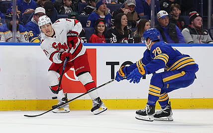 Feb 25, 2024; Buffalo, New York, USA;  Buffalo Sabres defenseman Jacob Bryson (78) tries to block a pass by Carolina Hurricanes right wing Jesper Fast (71) during the first period at KeyBank Center. Mandatory Credit: Timothy T. Ludwig-USA TODAY Sports