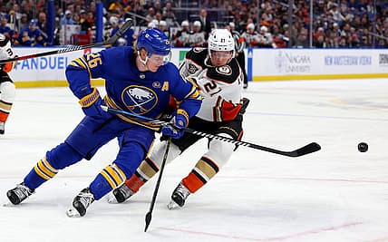 Feb 19, 2024; Buffalo, New York, USA;  Buffalo Sabres defenseman Rasmus Dahlin (26) clears the puck as Anaheim Ducks center Isac Lundestrom (21) defends during the first period at KeyBank Center. Mandatory Credit: Timothy T. Ludwig-USA TODAY Sports