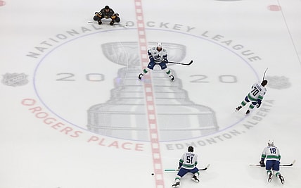 Aug 23, 2020; Edmonton, Alberta, CAN; Vancouver Canucks and Vegas Golden Knights players warm up at the center logo before game one of the second round of the 2020 Stanley Cup Playoffs at Rogers Place. Mandatory Credit: Gerry Thomas-USA TODAY Sports