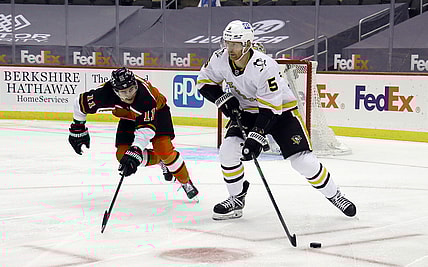 Apr 15, 2021; Pittsburgh, Pennsylvania, USA;  Pittsburgh Penguins defenseman Mike Matheson (5) moves the puck out of the defensive zone as Philadelphia Flyers right wing Travis Konecny (11) chases during the second period  at PPG Paints Arena. Mandatory Credit: Charles LeClaire-USA TODAY Sports