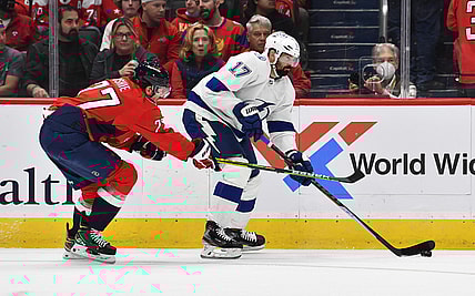 Oct 16, 2021; Washington, District of Columbia, USA; Tampa Bay Lightning left wing Alex Killorn (17) carries the puck as Washington Capitals right wing T.J. Oshie (77) defends during the first period at Capital One Arena. Mandatory Credit: Brad Mills-USA TODAY Sports