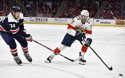 Nov 26, 2021; Washington, District of Columbia, USA; Florida Panthers left wing Carter Verhaeghe (23) carries the puck as Washington Capitals defenseman John Carlson (74) defends during the first period at Capital One Arena. Mandatory Credit: Brad Mills-USA TODAY Sports