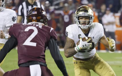 Oct 9, 2021; Blacksburg, Virginia, USA;  Notre Dame Fighting Irish running back Kyren Williams (23) runs the ball toward Virginia Tech Hokies defensive back Jermaine Waller (2) during the second quarter at Lane Stadium. Mandatory Credit: Reinhold Matay-USA TODAY Sports