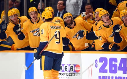 Nov 30, 2021; Nashville, Tennessee, USA; Nashville Predators left wing Filip Forsberg (9) is congratulated by teammates after a goal during the first period against the Columbus Blue Jackets at Bridgestone Arena. Mandatory Credit: Christopher Hanewinckel-USA TODAY Sports