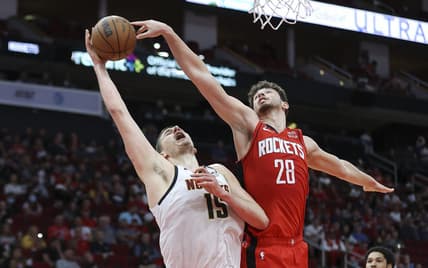 Feb 28, 2023; Houston, Texas, USA; Denver Nuggets center Nikola Jokic (15) attempts to score as Houston Rockets center Alperen Sengun (28) defends during the third quarter at Toyota Center. Mandatory Credit: Troy Taormina-USA TODAY Sports