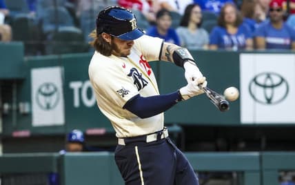Apr 21, 2023; Arlington, Texas, USA;  Texas Rangers catcher Jonah Heim (28) hits a three-run home run during the first inning against the Oakland Athletics  at Globe Life Field. Mandatory Credit: Kevin Jairaj-USA TODAY Sports