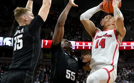 Dec 21, 2023; East Lansing, Michigan, USA; Stony Brook Seawolves guard Tyler Stephenson-Moore (14)can   t see an open shot past the defense of Michigan State Spartans forward Coen Carr (55) and Michigan State Spartans center Carson Cooper (15) at Jack Breslin Student Events Center. Mandatory Credit: Dale Young-USA TODAY Sports