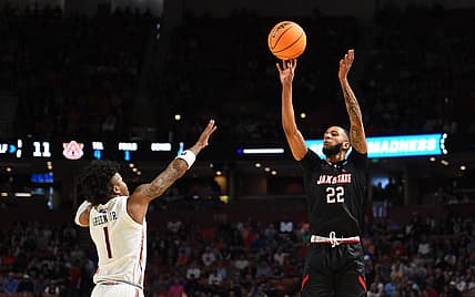 Mar 18, 2022; Greenville, SC, USA; Jackson State Tigers forward Chance Moore (22) shoots against Auburn Tigers guard Wendell Green Jr. (1) during the first round of the 2022 NCAA Tournament at Bon Secours Wellness Arena. Mandatory Credit: Bob Donnan-USA TODAY Sports