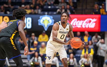 Nov 15, 2022; Morgantown, West Virginia, USA; West Virginia Mountaineers guard Kedrian Johnson (0) passes the ball during the second half against the Morehead State Eagles at WVU Coliseum. Mandatory Credit: Ben Queen-USA TODAY Sports