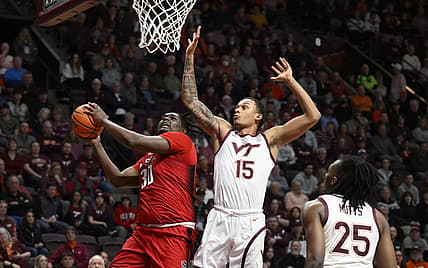 Jan 7, 2023; Blacksburg, Virginia, USA; North Carolina State Wolfpack forward D.J. Burns Jr. (30) drives to basket against Virginia Tech Hokies center Lynn Kidd (15) in the first half at Cassell Coliseum. Mandatory Credit: Lee Luther Jr.-USA TODAY Sports