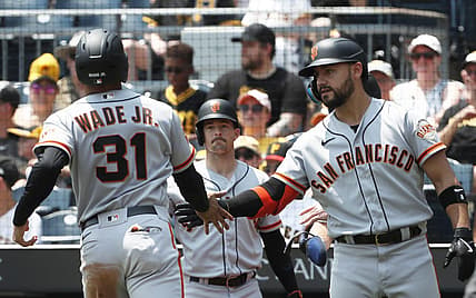 Jul 16, 2023; Pittsburgh, Pennsylvania, USA; San Francisco Giants right fielder Michael Conforto (8) greets first baseman LaMonte Wade Jr. (31) crossing home plate to score a run against the Pittsburgh Pirates during the third inning at PNC Park. Mandatory Credit: Charles LeClaire-USA TODAY Sports