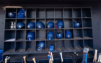 Mar 19, 2022; Peoria, Arizona, USA; A general view of hats and bats belonging the the Los Angeles Dodgers before spring training game against the Seattle Mariners at Peoria Sports Complex. Mandatory Credit: Allan Henry-USA TODAY Sports