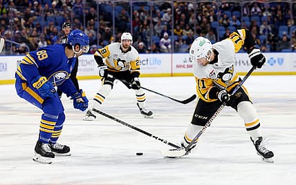 Nov 24, 2023; Buffalo, New York, USA;  Buffalo Sabres right wing Alex Tuch (89) and Pittsburgh Penguins left wing Alex Nylander (11) go after a loose puck during the first period at KeyBank Center. Mandatory Credit: Timothy T. Ludwig-USA TODAY Sports