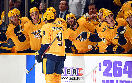 Nov 30, 2021; Nashville, Tennessee, USA; Nashville Predators left wing Filip Forsberg (9) is congratulated by teammates after a goal during the first period against the Columbus Blue Jackets at Bridgestone Arena. Mandatory Credit: Christopher Hanewinckel-USA TODAY Sports