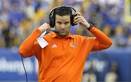 Oct 30, 2021; Pittsburgh, Pennsylvania, USA;  Miami Hurricanes head coach Manny Diaz puts his headset on against the Pittsburgh Panthers during the fourth quarter at Heinz Field. Mandatory Credit: Charles LeClaire-USA TODAY Sports