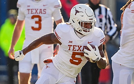 Nov 19, 2022; Lawrence, Kansas, USA; Texas Longhorns running back Bijan Robinson (5) runs the ball during the first half against the Kansas Jayhawks at David Booth Kansas Memorial Stadium. Mandatory Credit: Jay Biggerstaff-USA TODAY Sports