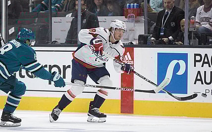 Mar 4, 2023; San Jose, California, USA; Washington Capitals defenseman Rasmus Sandin (38) flips the puck away from San Jose Sharks left winger Andreas Johnsson (18) during the first period at SAP Center at San Jose. Mandatory Credit: D. Ross Cameron-USA TODAY Sports