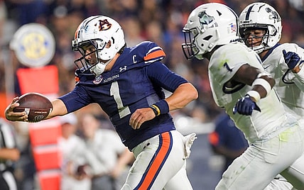 Auburn Tigers quarterback Payton Thorne (1) stretches the ball out as he crosses the goalline for a touchdown against Samford Bulldogs defensive back Kourtlan Marsh (1) during second half action in the AU vs. Samford game at Jordan-Hare Stadium in the AU campus in Auburn, Ala., on Saturday September 16, 2023.