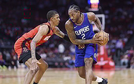 Mar 6, 2024; Houston, Texas, USA; Los Angeles Clippers forward Kawhi Leonard (2) controls the ball as Houston Rockets forward Jabari Smith Jr. (10) defends during the first quarter at Toyota Center. Mandatory Credit: Troy Taormina-USA TODAY Sports