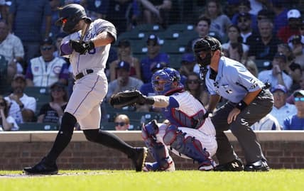 Sep 18, 2022; Chicago, Illinois, USA; Colorado Rockies right fielder Randal Grichuk (15) hits a two-run single against the Chicago Cubs during the first inning at Wrigley Field. Mandatory Credit: David Banks-USA TODAY Sports