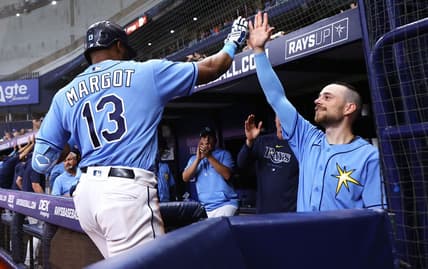 Apr 8, 2023; St. Petersburg, Florida, USA; Tampa Bay Rays right fielder Manuel Margot (13) is congratulated by second baseman Brandon Lowe (8) after hitting a home run against the Oakland Athletics during the sixth inning at Tropicana Field. Mandatory Credit: Kim Klement-USA TODAY Sports