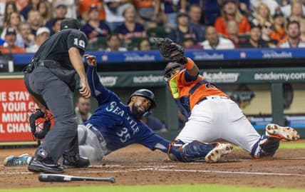 Aug 18, 2023; Houston, Texas, USA; Home plate umpire Alex MacKay calls Seattle Mariners right fielder Teoscar Hernandez (35) out at home as he is tagged by Houston Astros catcher Martin Maldonado (15)  in the fourth inning at Minute Maid Park. Mandatory Credit: Thomas Shea-USA TODAY Sports